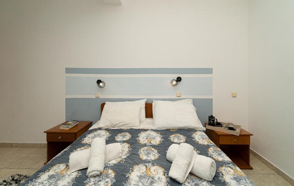 A maisonette bedroom with a double bed, modern wall design and bedside tables