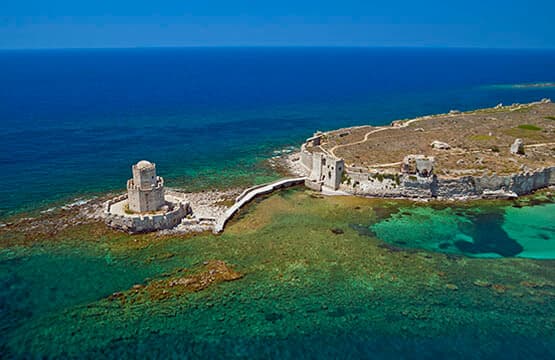 Methoni Castle and the Bourtzi tower above turquoise water