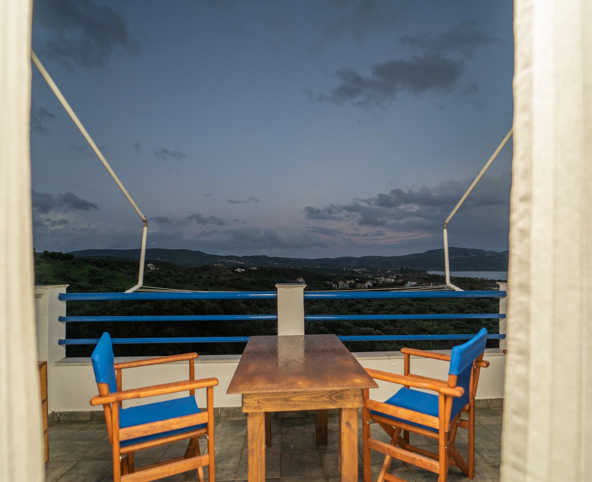 An evening view from a veranda at Blue Houses towards the hills and the sea at Finikounda